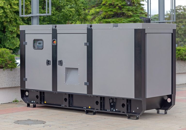 Large gray industrial generator on a sidewalk