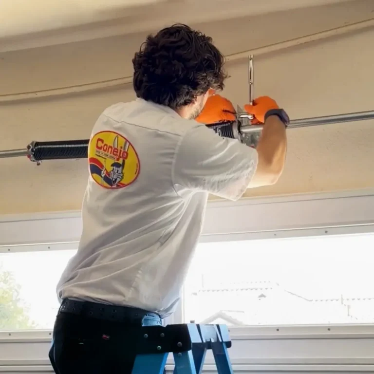 Conejo Services technician working on garage door springs