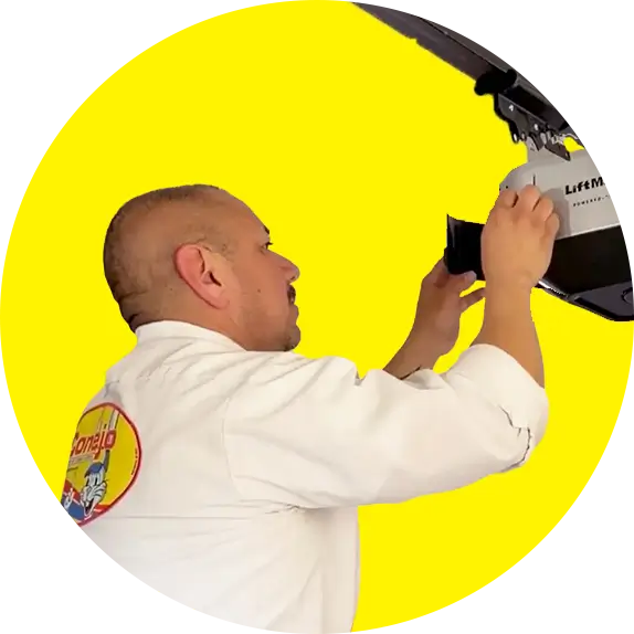 Conejo Services garage door technician installing a LiftMaster opener